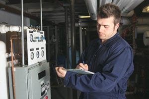 tech performing heating system inspection